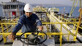 A worker checks the valve gears of pipes linked to oil tanks at Turkey's Mediterranean port of Ceyhan